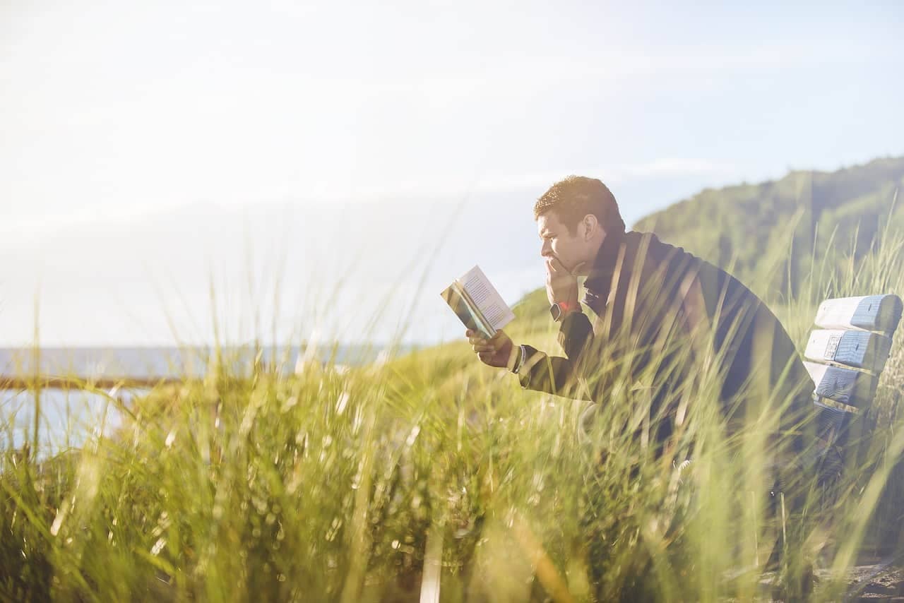 A person enjoying a relaxing activity, like reading in a cozy nook