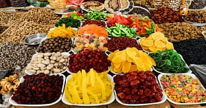 A colorful variety of anti-inflammatory foods including berries, avocado, broccoli and turmeric arranged on a wooden table